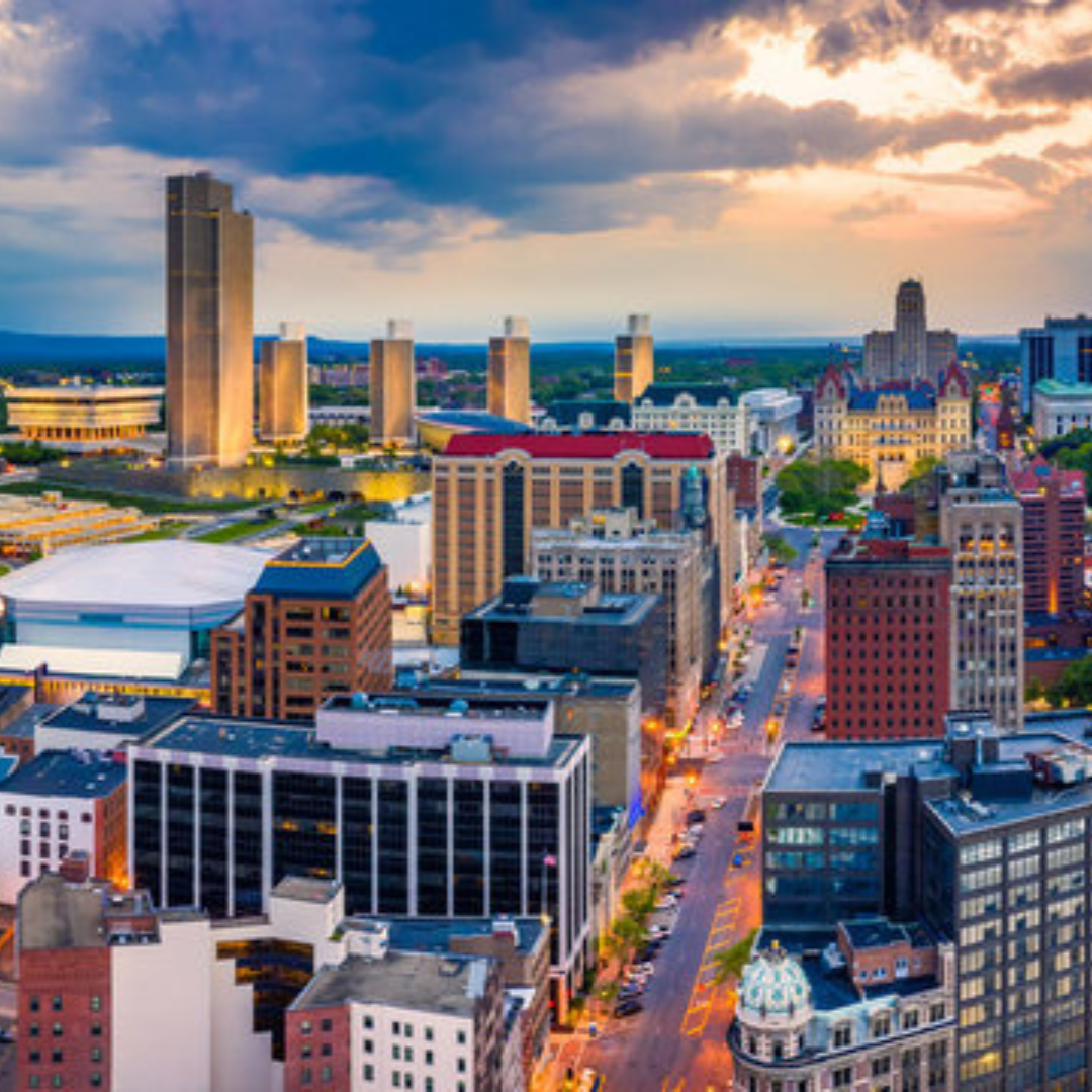 Aerial evening view of downtown Albany, showcasing city lights and the urban landscape.